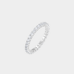 Silver ring with small diamonds on a light gray background