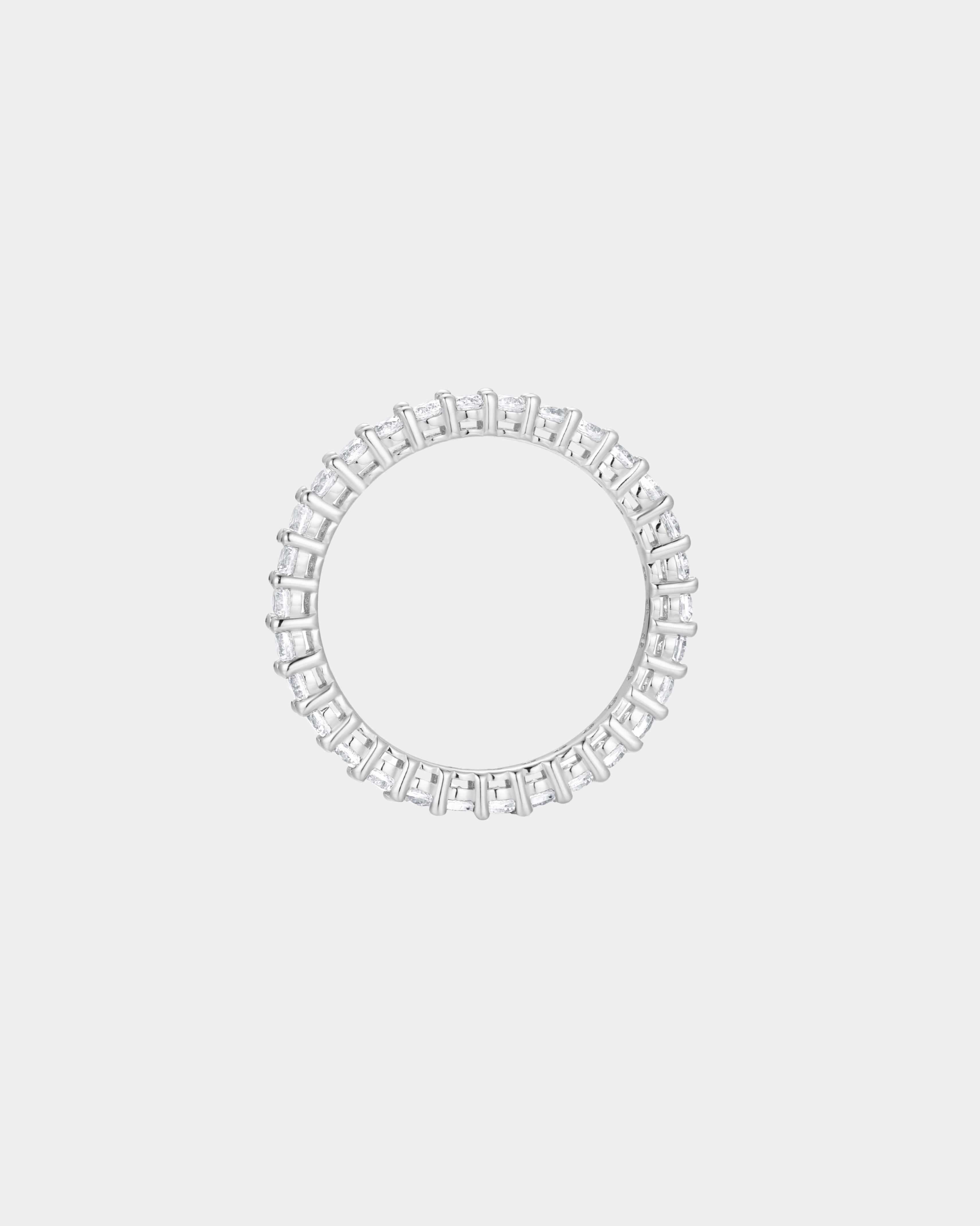 Diamond ring with a circular band on a light gray background