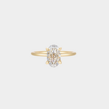 Gold ring with a oval shaped diamond on a light gray background