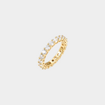 Gold ring with embedded diamonds on a light gray background