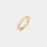 Gold ring with embedded diamonds on a light gray background