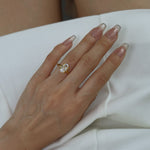 hand wearing ciel ring on a white dress