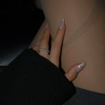 Hand with a ring on a dark background