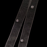 Two black ribbons with LUME's Stella studs on a clear background