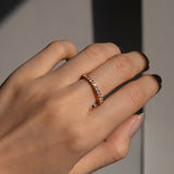 Close-up of a hand wearing the selene ring on a neutral background