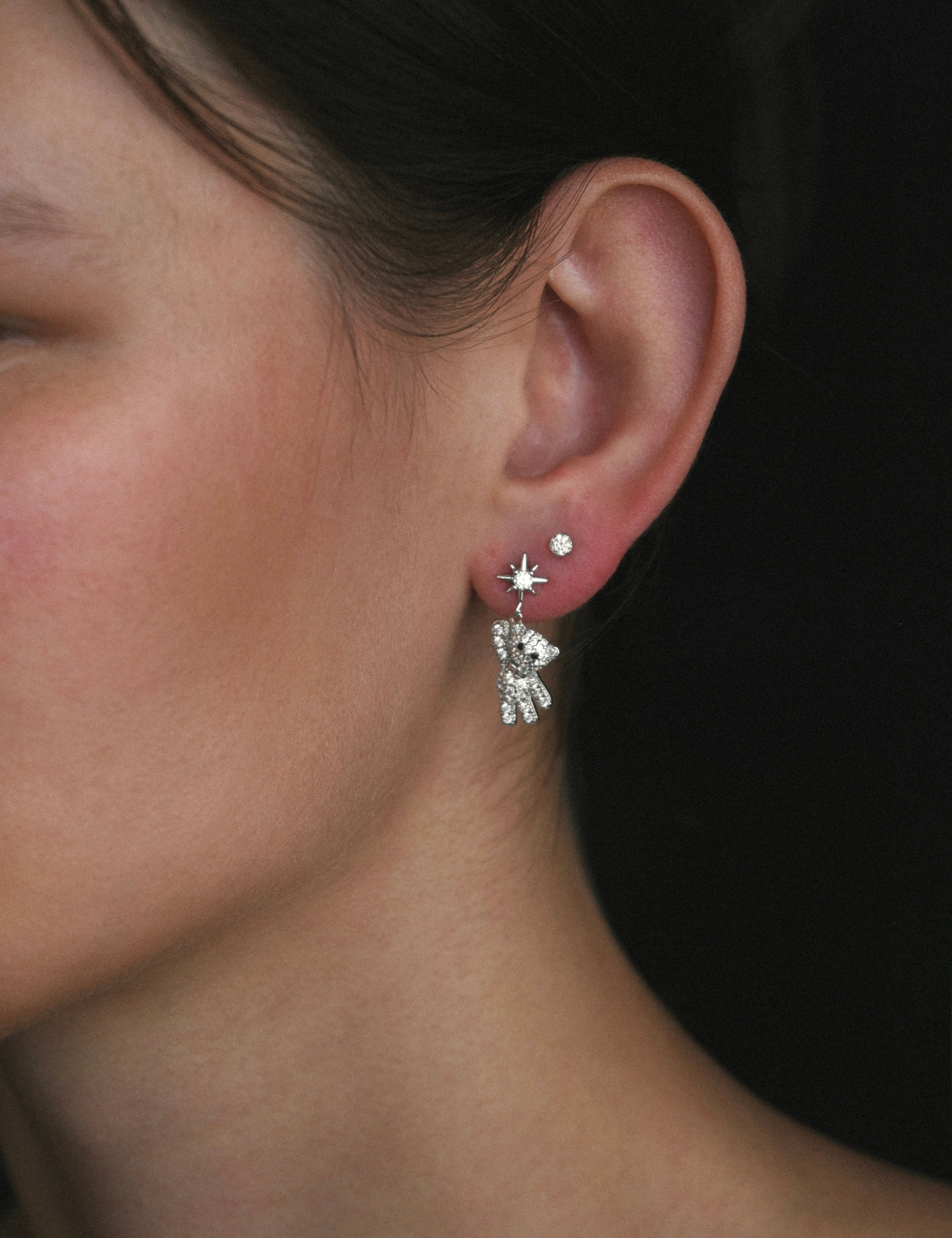 model wearing the starry teddy earrings and stella studs from lume jewellery on her ear 
