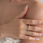 Close-up of a model with hand wearing lume jewellery's celeste ring ring with a blurred background
