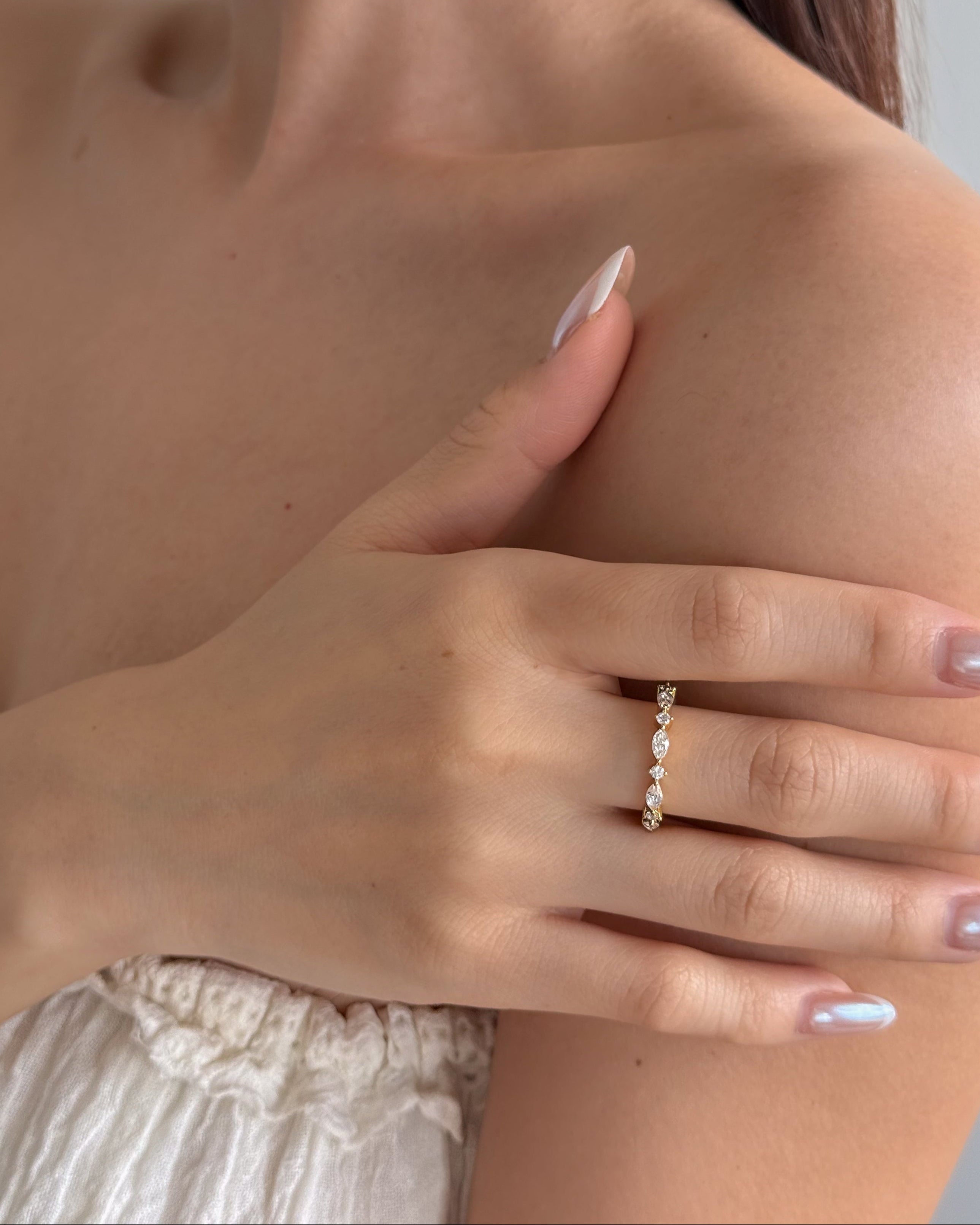 Close-up of a model with hand wearing lume jewellery's celeste ring ring with a blurred background
