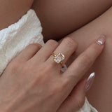 gold ring with a diamond on a hand against resting on legs