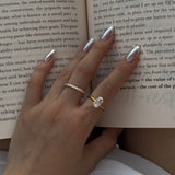 Hand with rings on an open book