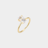 Gold ring with a diamond on a light gray background
