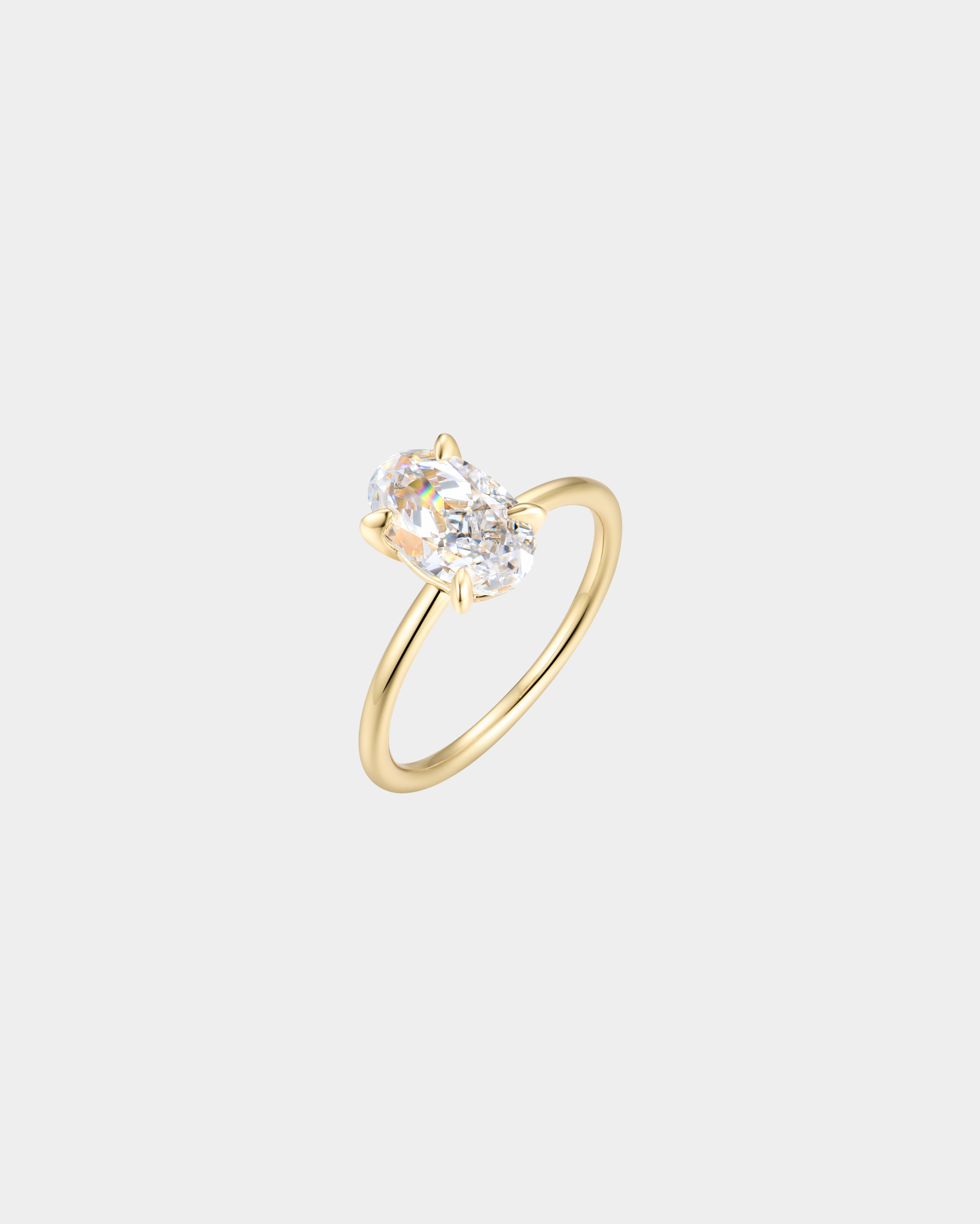 Gold ring with a diamond on a light gray background