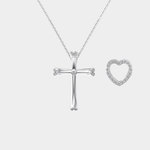 Silver cross and heart-shaped pendant on a chain against a white background