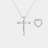 Silver cross and heart-shaped pendant on a chain against a white background