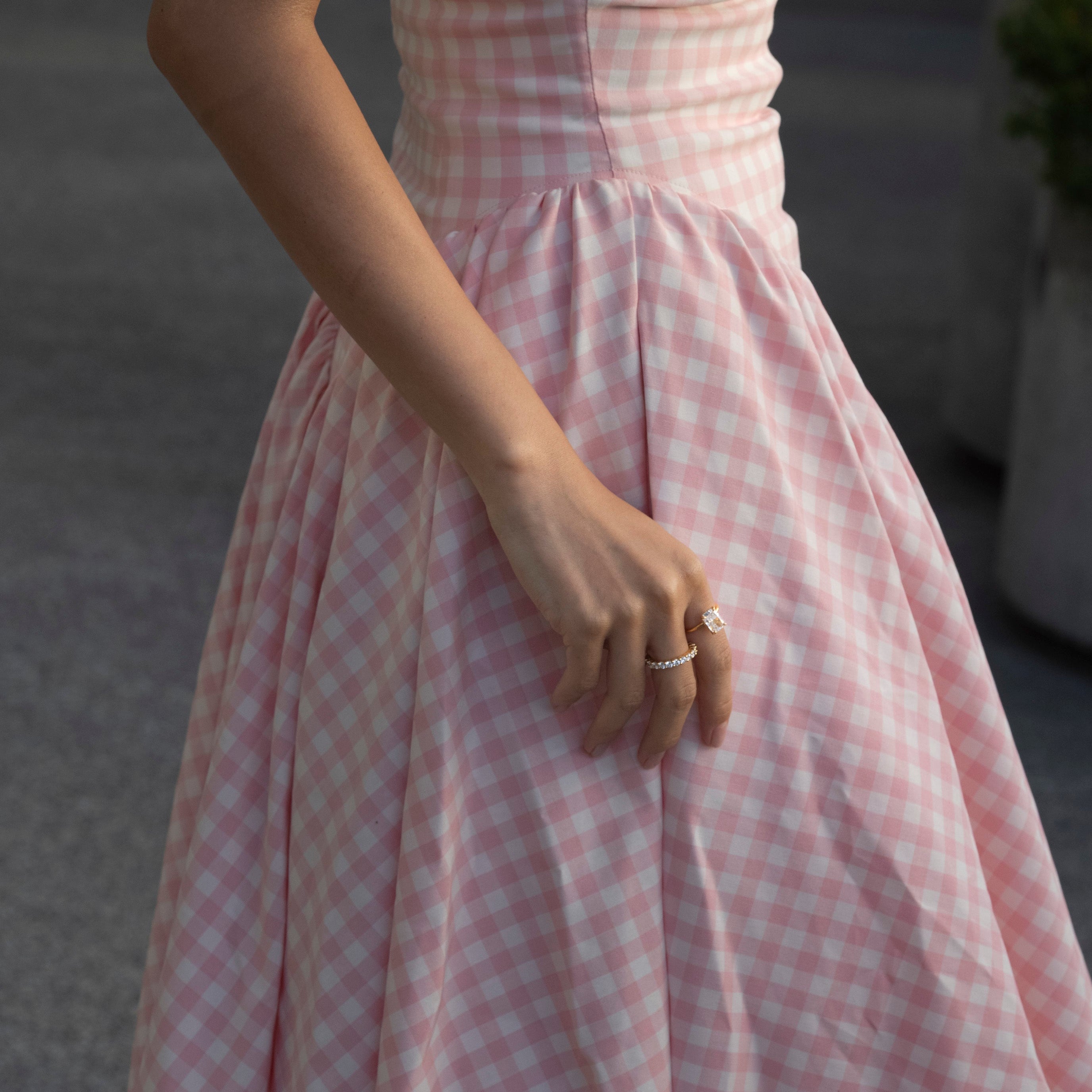 model wearing lume jewellery's elodie ring and dues ring and a pink dress
