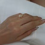 Hand wearing a ciel ring on a white dress